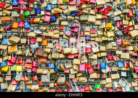 Molti lucchetti in diversi colori in un recinto a Colonia, in Germania. Foto Stock