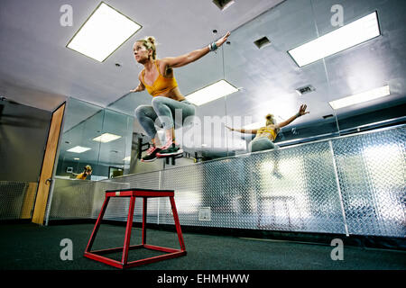 La donna caucasica lavoro in palestra Foto Stock