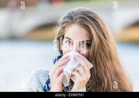 Donna con un freddo utilizzando un tessuto. Foto Stock