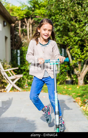 Bambini su scooter all'esterno. Foto Stock