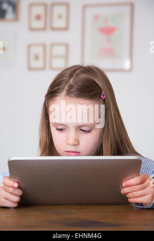 5 anno-vecchia ragazza utilizzando computer tablet. Foto Stock