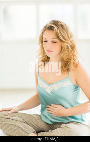 La donna che soffre di dolori addominali. Foto Stock