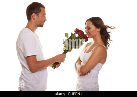 Il marito che offre una rosa a sua moglie felice Foto Stock