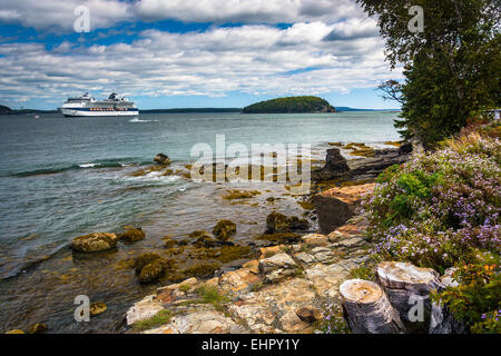 Costa rocciosa e la vista della nave da crociera e isola nella baia di francese a Bar Harbor, Maine. Foto Stock