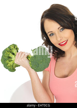 Giovane donna attraente azienda materie broccoli Foto Stock