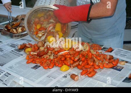 Una festa a base di pesce, fango bug bollire, la vita in America Foto Stock