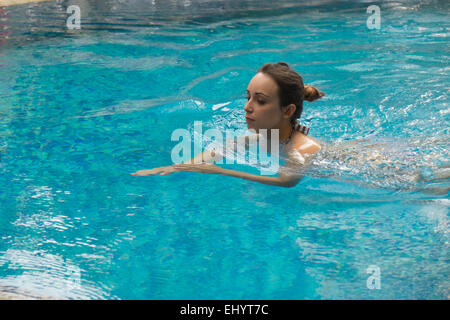 Donna di nuoto in piscina Foto Stock