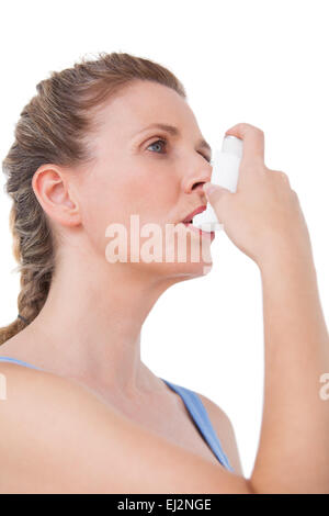Donna che utilizza un inalatore per l'asma Foto Stock