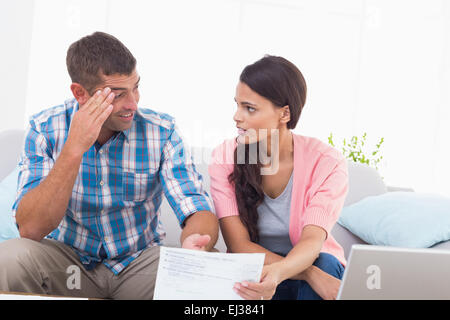 Sottolineato giovane discutendo su home le finanze Foto Stock