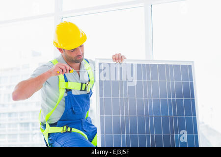 Lavoratore di serraggio del pannello solare in office Foto Stock