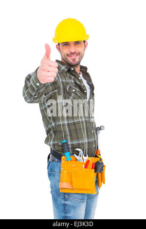 Fiducioso lavoratore manuale gesticolando pollice in alto Foto Stock