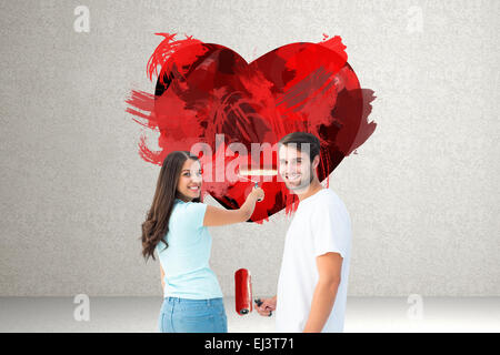 Immagine composita di felice coppia giovane pittura insieme Foto Stock