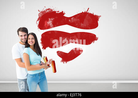 Immagine composita di felice coppia giovane pittura insieme Foto Stock