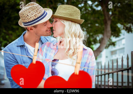 Immagine composita di hip coppia giovane kissing da ringhiere Foto Stock