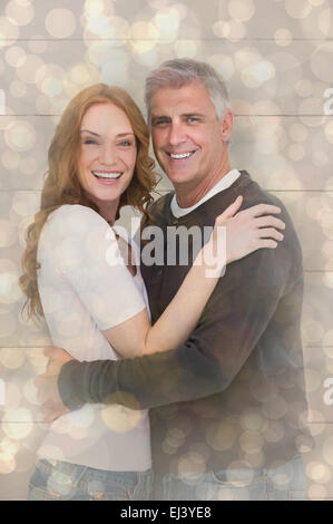 Immagine composita di casual Coppia sorridente in telecamera Foto Stock