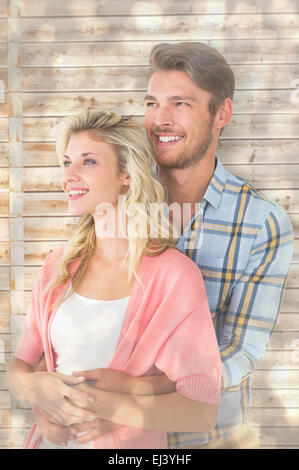 Immagine composita di attraente coppia giovane abbracciando e sorridente Foto Stock