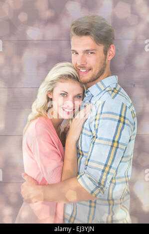 Immagine composita della coppia attraente abbracciando e sorridente in telecamera Foto Stock
