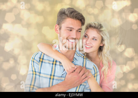 Immagine composita della coppia attraente abbracciando e sorridente Foto Stock