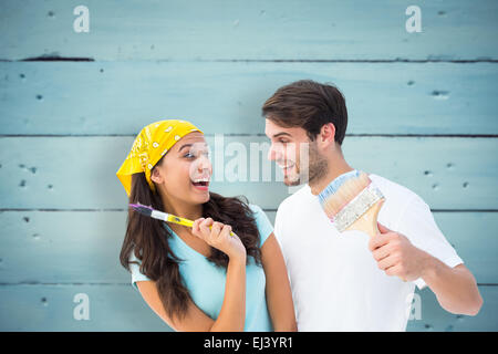 Immagine composita di felice coppia giovane pittura insieme e ridere Foto Stock
