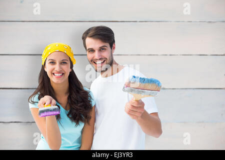 Immagine composita di felice coppia giovane pittura insieme Foto Stock