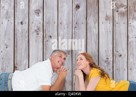 Immagine composita di casual giovane sdraiato sul pavimento Foto Stock