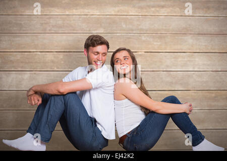 Immagine composita della coppia giovane seduto sul pavimento Foto Stock