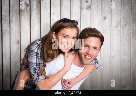 Immagine composita del ritratto di uomo sorridente che trasportano donna Foto Stock