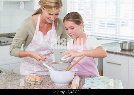 Madre e figlia rendendo torta insieme Foto Stock