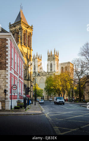 Street View di Duncombe Place all'alba con St Wilfrid la chiesa e York Minster immerso nella luce del sole dorato Foto Stock