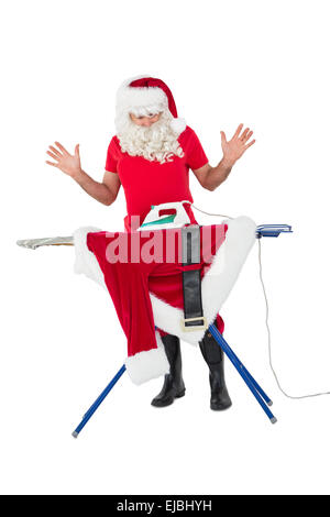 Sorpreso di Babbo Natale di stirare la sua camicia Foto Stock