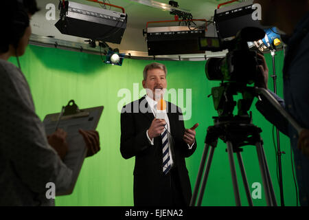 Presentatore maschio in televisione Stdio con equipaggio in primo piano Foto Stock