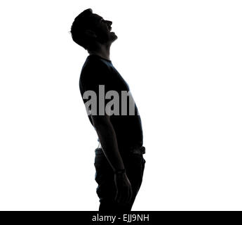 Silhouette in profilo di un atletico caucasian uomo di mezza età che indossa la t-shirt e jeans gridando. Foto Stock