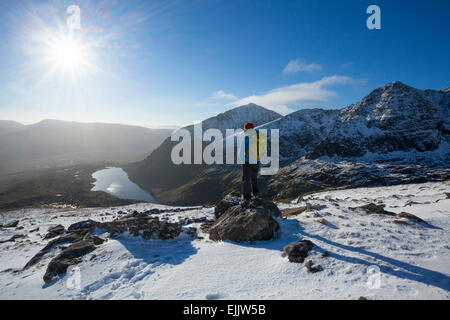 Inverno walker cerca su Lough Cruite da Brandon Mountain, penisola di Dingle, nella contea di Kerry, Irlanda. Foto Stock