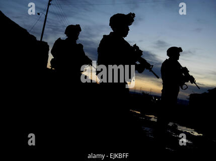 Stati Uniti I soldati dell esercito di fornire un cordone esterno del villaggio come polizia irachena dai servizi di emergenza unità condurre una ricerca di Qarah Cham village in Iraq, 27 marzo 2007. I soldati sono assegnati alla sede centrale e sede azienda, sede del plotone, 2° Battaglione, 27° Reggimento di Fanteria, 3° Brigata Team di combattimento, XXV divisione di fanteria, Schofield caserma, Hawaii. Master Sgt. Andy Dunaway Foto Stock