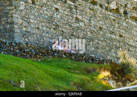 I visitatori in appoggio all'ombra di Criccieth Castle, Gwynedd, il Galles del Nord. Foto Stock