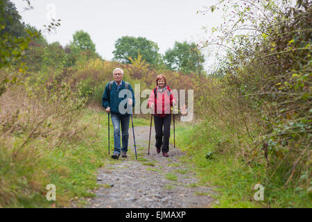 Coppia senior Nordic walking sul sentiero roccioso nella natura. Foto Stock