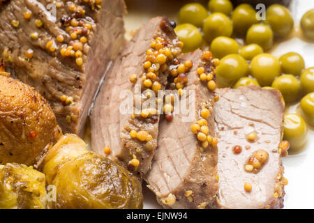 Fette di arrosto di manzo con cavolini di Bruxelles e piselli. Chiudere l immagine della carne sfondo alimentare. Foto Stock