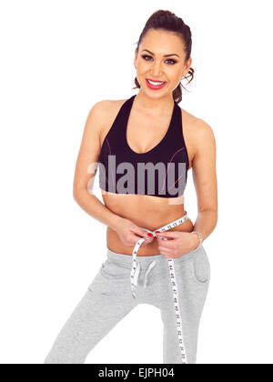 Attraente slim fit giovane donna con nastro di misurazione Foto Stock
