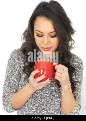 Felice positivo giovane donna godendo di tazza rinfrescante di fresco tè caldo o bevanda di caffè, isolato su bianco, da soli Foto Stock