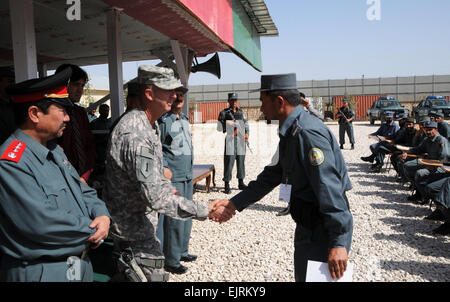 Il cap. Amandullah della polizia nazionale afgana accetta il suo certificato di laurea da Col. Stephen G. Yackley, Sostituto del comandante generale, lo sviluppo della polizia di sicurezza combinato, combinata di sicurezza Command-Afghanistan di transizione. Amanduallah era uno dei due laureati di ANP per essere la prima volta destinatari del Col. Quayum Leadership Award. Amandullah e 200 altri membri dell'ANP si è laureato dalla Konduz Centro di Formazione Regionale sett. 16. foto di Sottufficiali di prima classe Douglas Mappin rilasciato Foto Stock