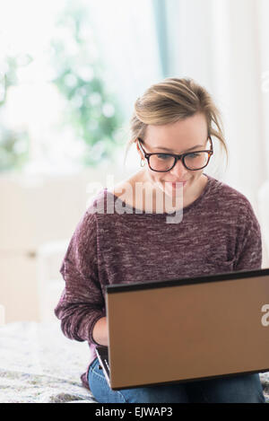 Giovane donna utilizzando laptop Foto Stock