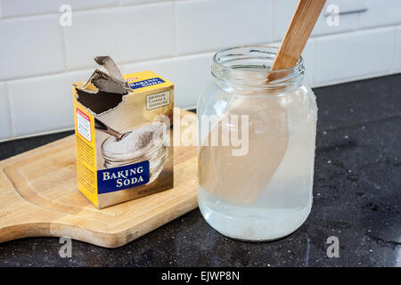 Agitazione bicarbonato di sodio in un vasetto di vetro Foto Stock