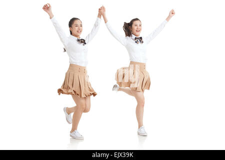 Due high school girls holding hands eseguire Foto Stock