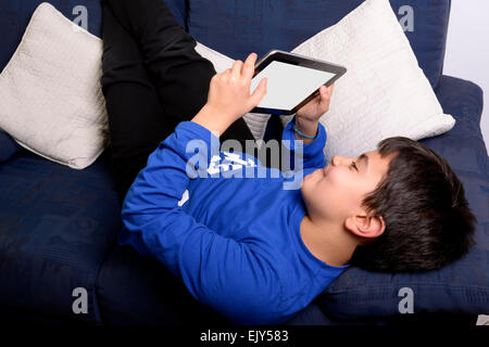 Bambino utilizza un Tablet per comunicare e giocare. Foto Stock