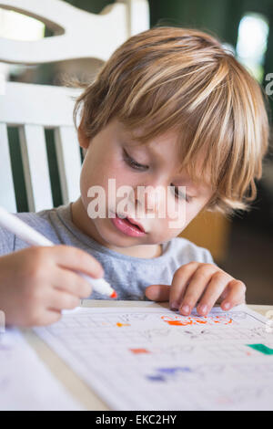 Ragazzo giovane facendo i compiti di scuola Foto Stock