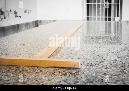 Wood on granite. Close up image of a wood in form of "T" Foto Stock