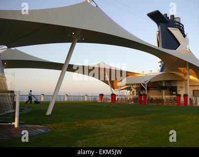 Un uomo di falciare un prato sul ponte della nave da crociera Celebrity Equinox. Foto Stock