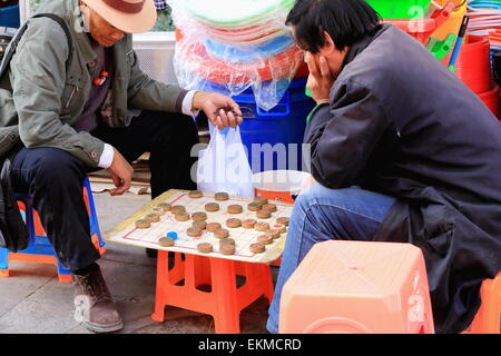 LHASA, in Tibet, Cina-ottobre 19: due uomini scacchi cinesi-goh al di fuori del negozio nella strada del mercato di Barkhor area-Lhasa Foto Stock