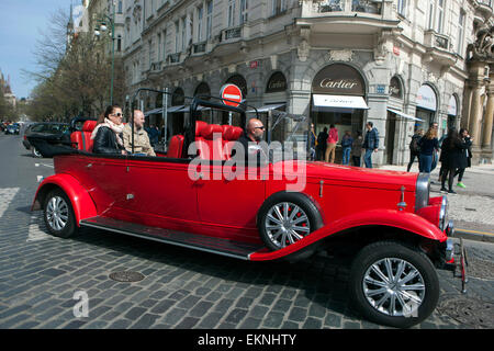 I turisti in imitazione di auto d'epoca corrono via Parizska Praga, città Vecchia, Repubblica Ceca Foto Stock