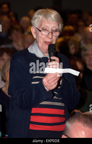 Donna anziana che pongono una questione ad un pannello di politici a un evento hustings prima delle elezioni generali britanniche il 7 maggio 2015, Fa Foto Stock